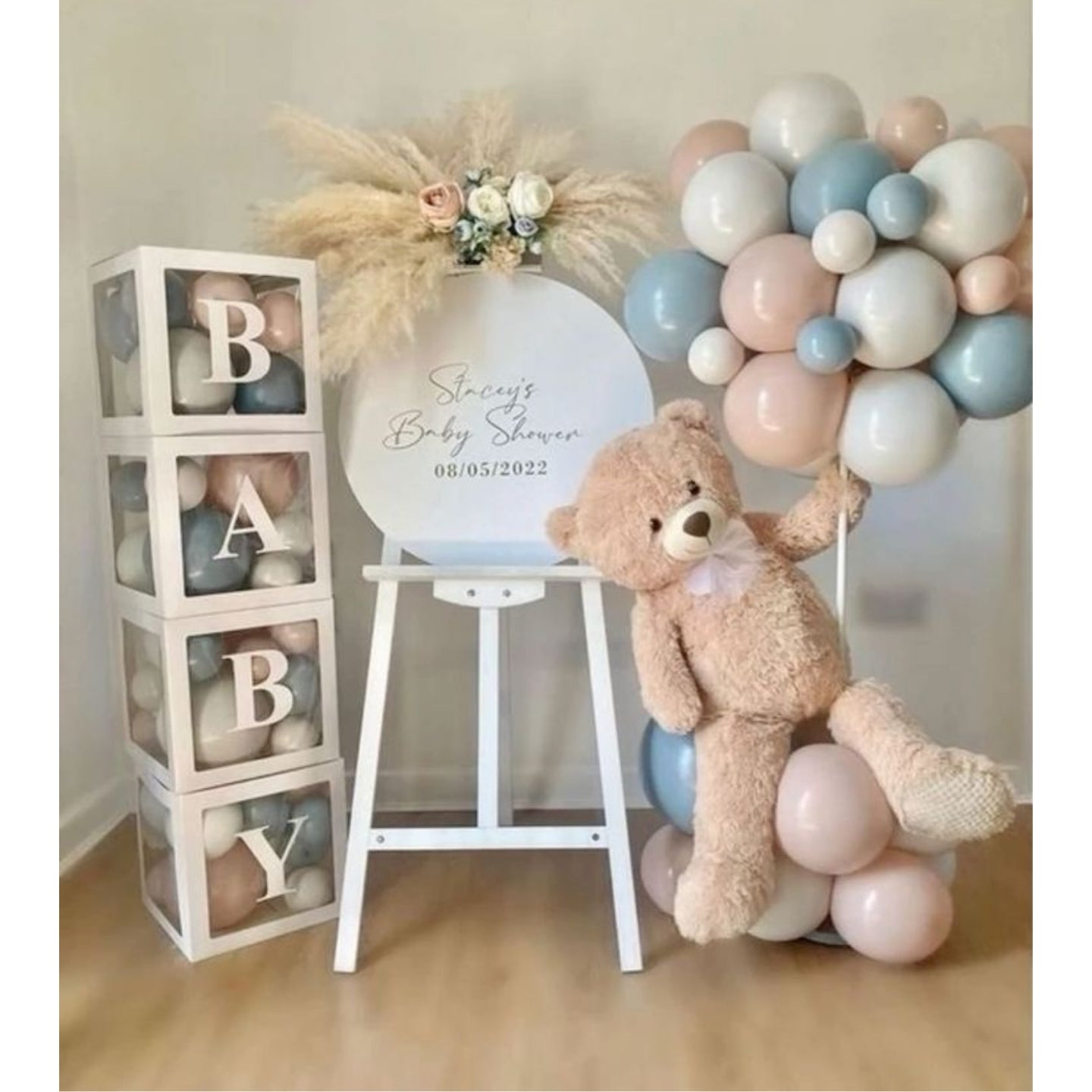 New Born Baby shower setup with teddy bear, balloons, and decorative blocks.