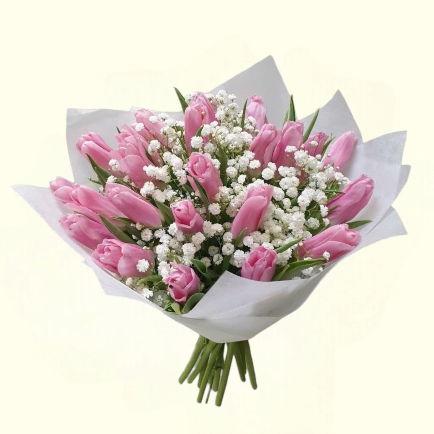 Bouquet of pink tulips and white flowers wrapped in white paper on a light beige background