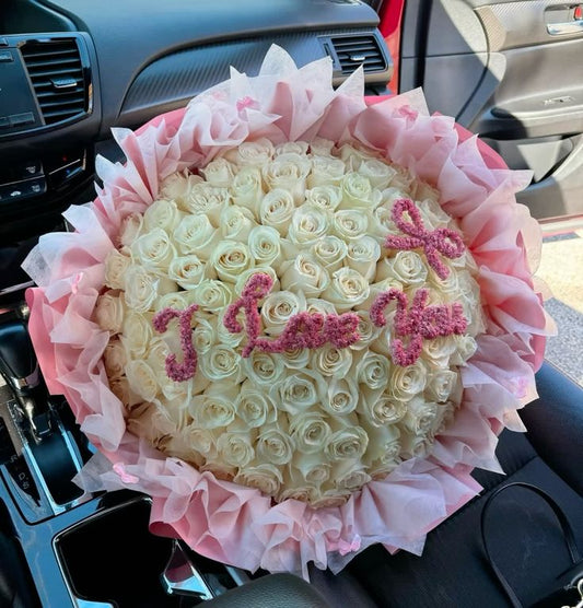 White roses bouquet with pink wrapping 