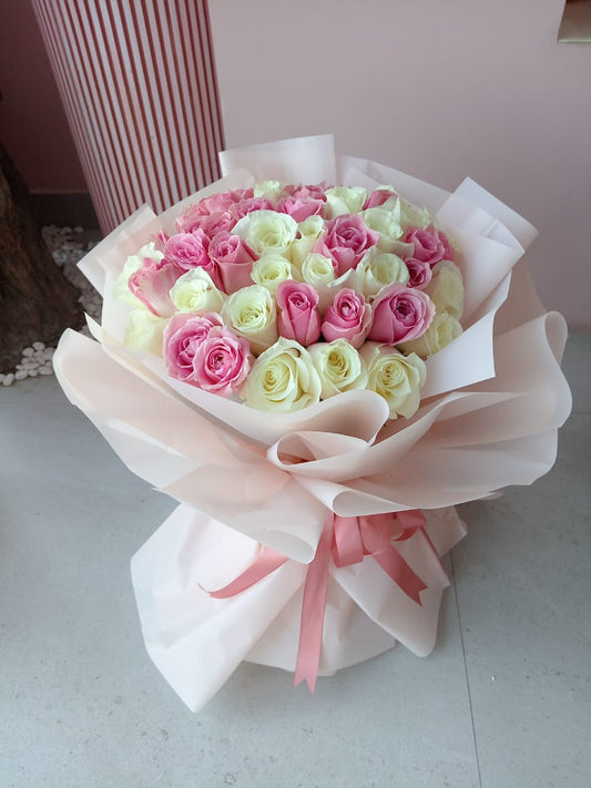 Pink and White roses bouquet with light pink wrapping 