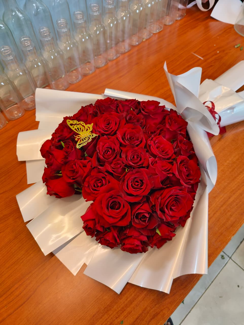 Butterfly red roses bouquet with white wrapping 