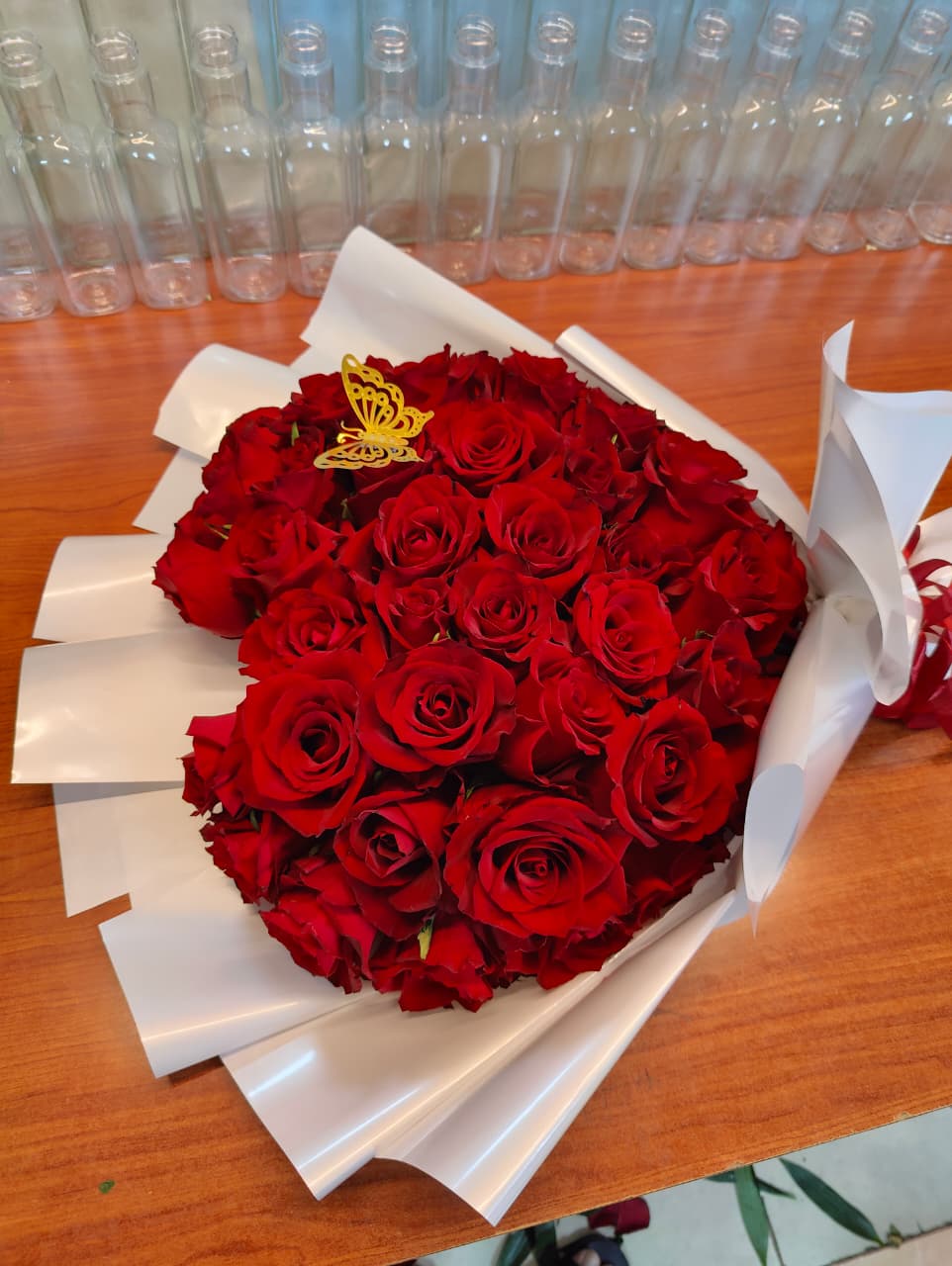 Butterfly red roses bouquet with white wrapping 