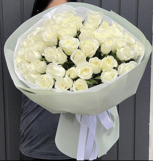 White roses flower bouquet with white wrapping