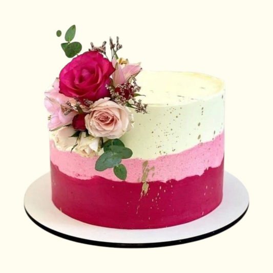 Decorative cake with pink and white layers and flowers on a white background