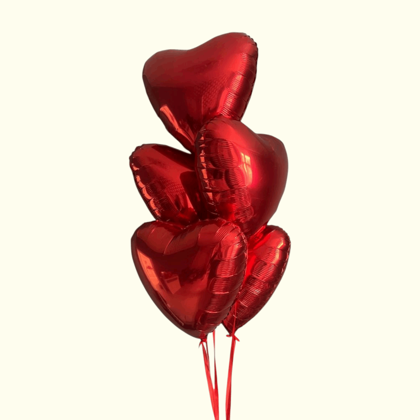 Red heart-shaped balloons on a white background