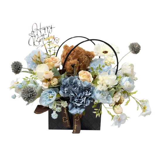 Floral arrangement with a teddy bear and 'Happy Birthday' text