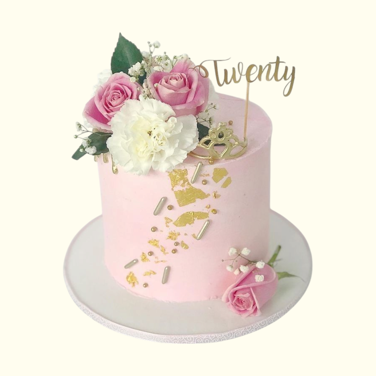 Pink cake with floral decorations and a 'Twenty' topper on a white background