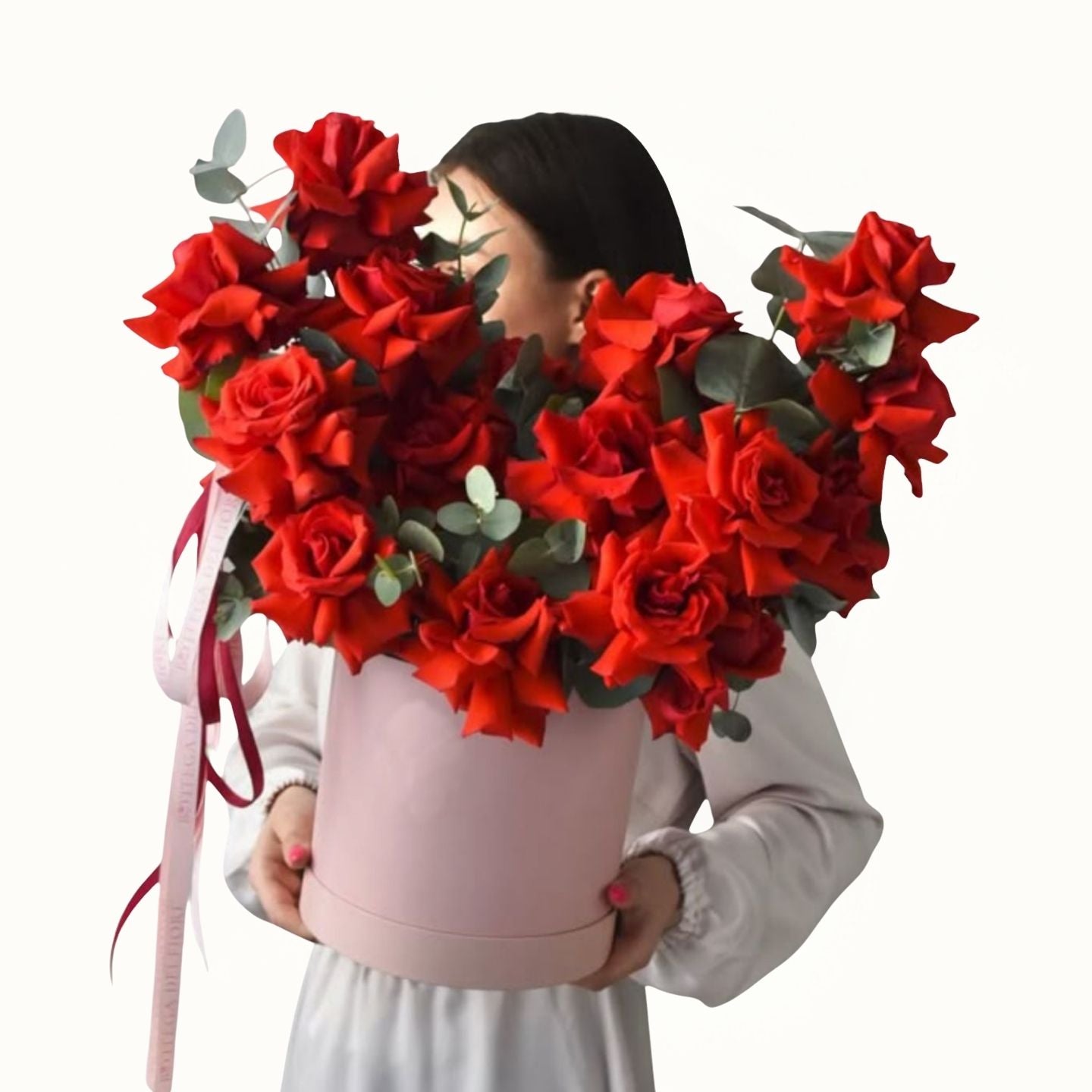 Person holding a large bouquet of red roses with a white background