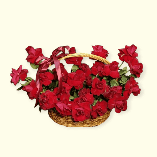 Basket of red roses with a red ribbon on a beige background