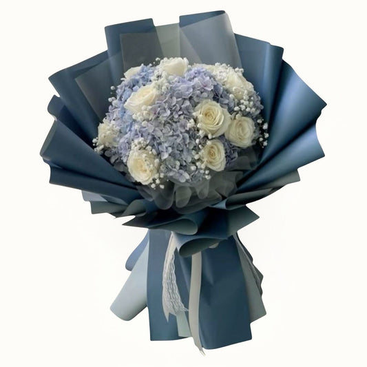 Bouquet of flowers wrapped in blue paper on a white background