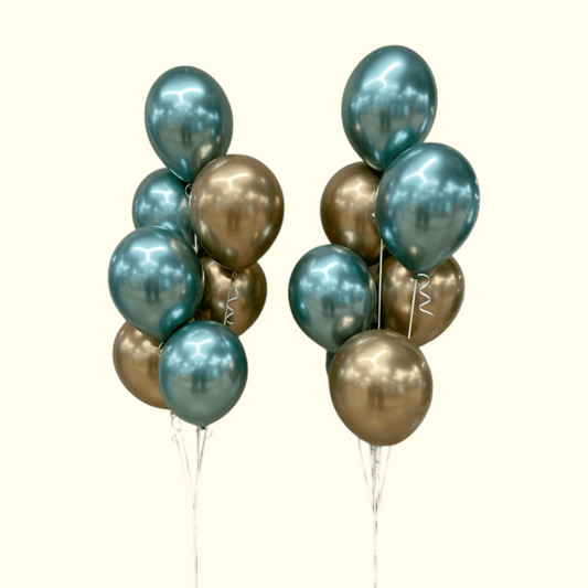 Two bunches of teal and gold balloons on a white background