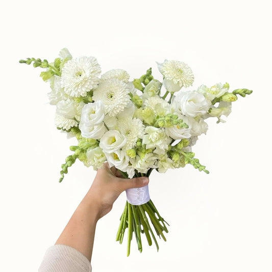 Hand holding white flower bouquet | bridal flower bouquet