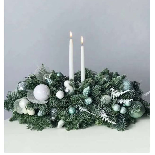 Decorative Christmas wreath with candles on a plain background