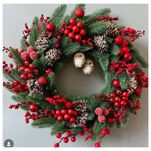 Christmas wreath with red berries and pinecones on a light gray background