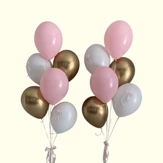 Bunch of pink, gold, and white balloons on a white background