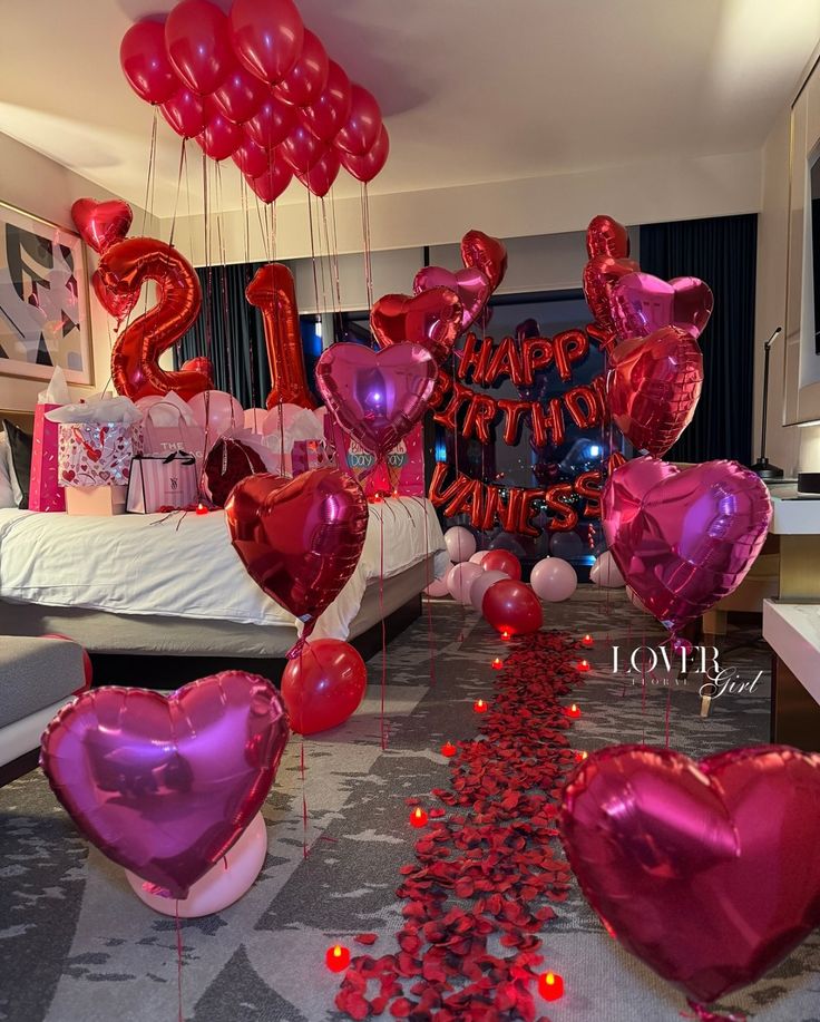 21 birthday setup with red heart balloons and roses 