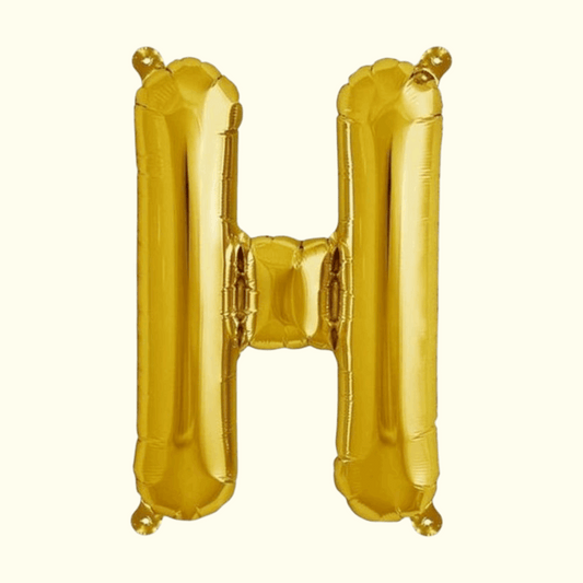 Gold letter 'H' balloon on a white background