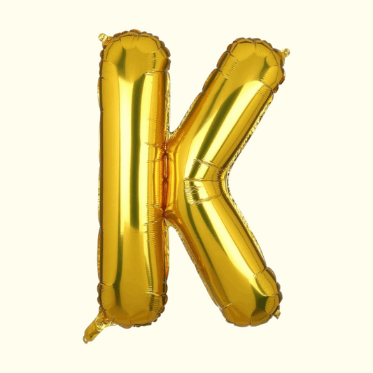 Gold letter 'K' balloon on a white background