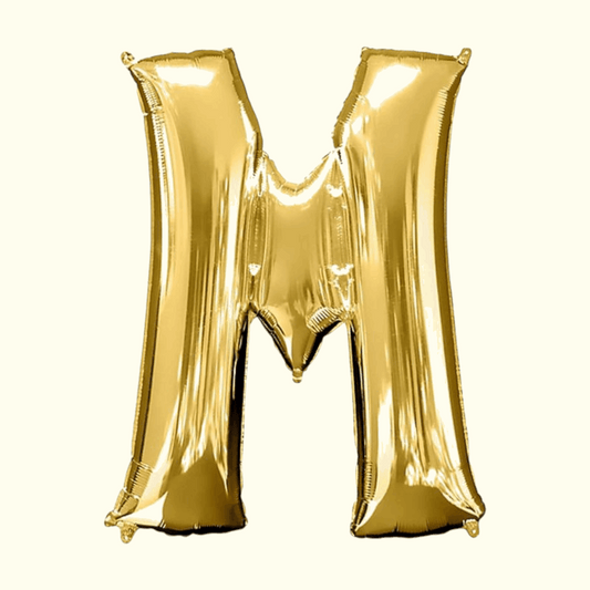 Gold letter 'M' balloon on a white background