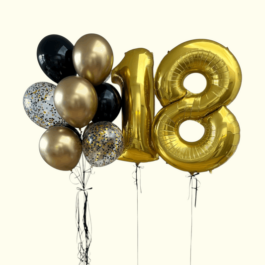Gold number '18' balloon and other balloons on a white background