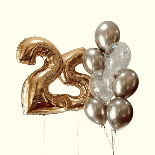 Gold number 25 balloon and silver balloons on a white background