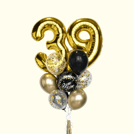 Gold number 39 balloon with other balloons on a white background