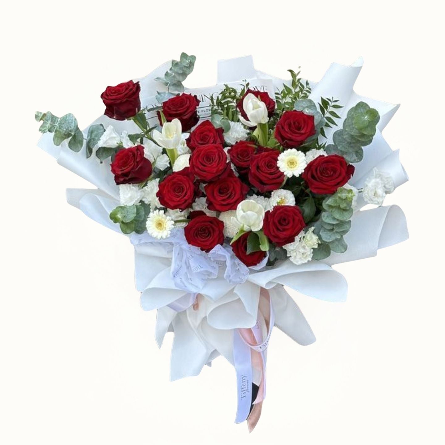 Bouquet of red and white roses with greenery on a white background