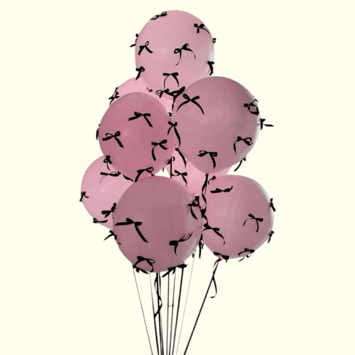 Pink balloons with black ribbons on a white background