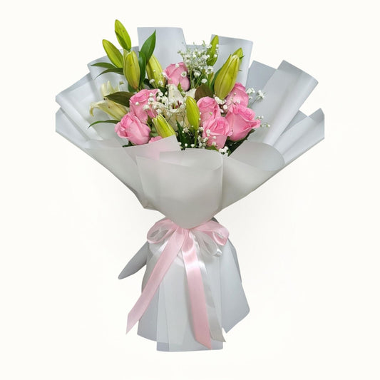 Bouquet of flowers wrapped in white paper with a pink ribbon on a white background