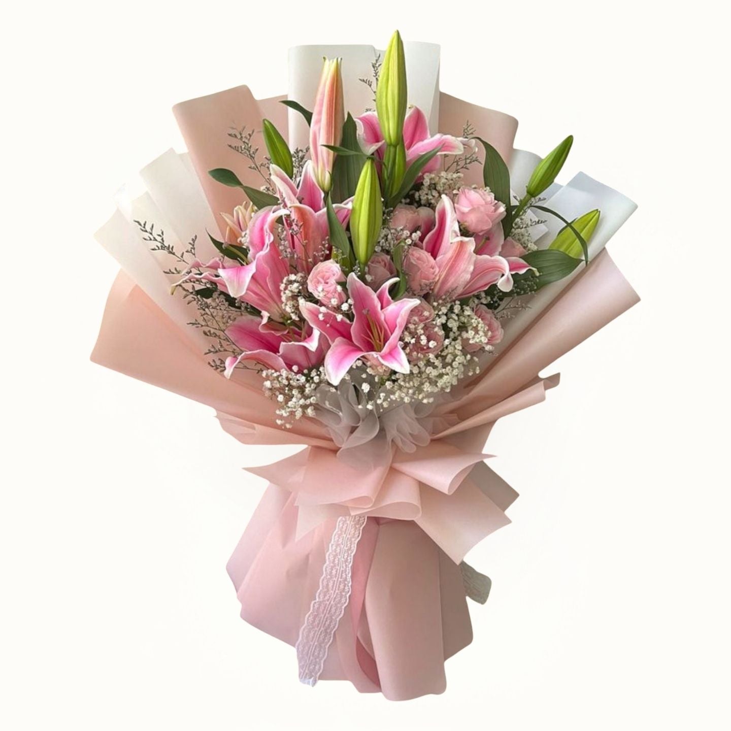 Bouquet of pink lilies wrapped in pink paper with a bow on a white background