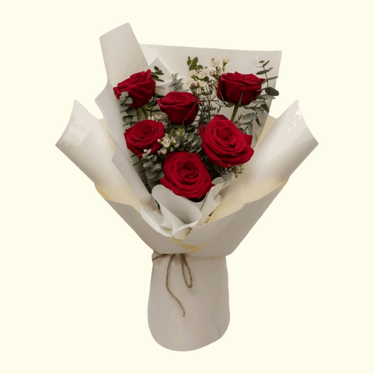 red roses flower bouquet with white wrapping.