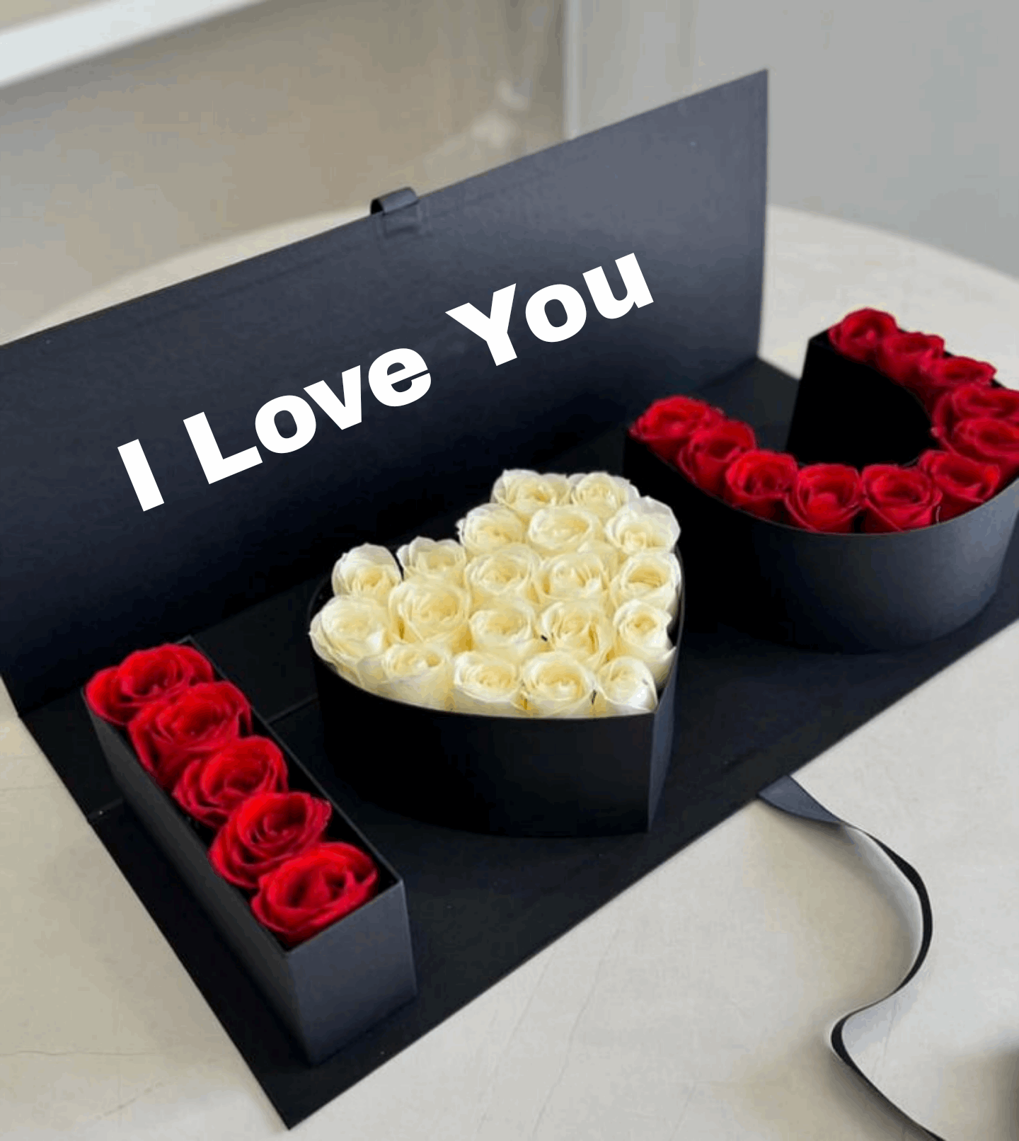 Heart-shaped boxes with white and red roses and 'I Love You' message