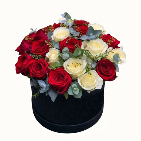 Black box with red, white, and yellow roses on a white background