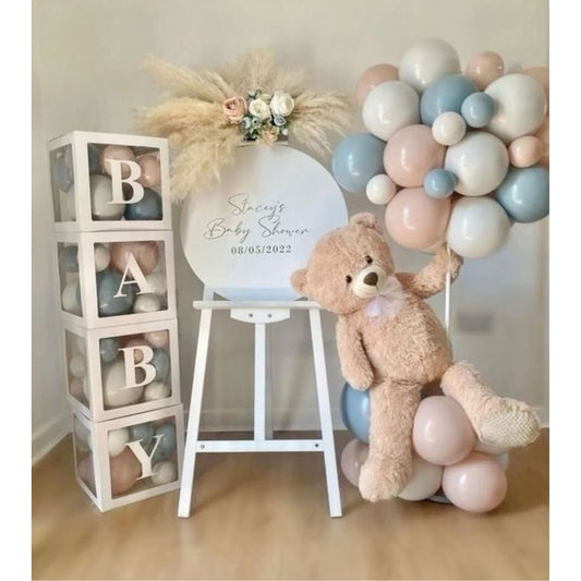 New Born Baby shower setup with teddy bear, balloons, and decorative blocks.
