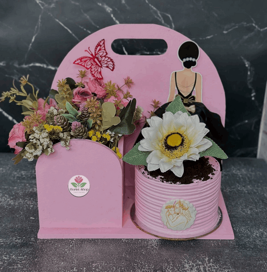 Pink decorative stand with floral arrangements on a dark marble surface