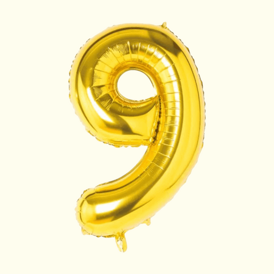 Gold number 9 balloon on a white background