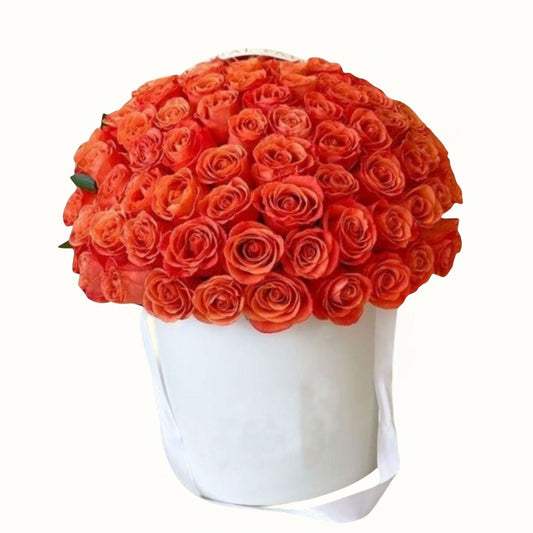 White box filled with bright orange roses on a white background