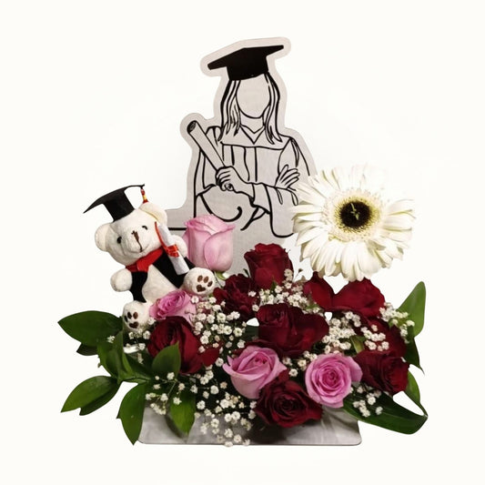 Graduation-themed arrangement with flowers, a teddy bear, and a plush monkey on a white background.