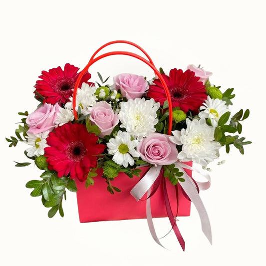 Red, Pink and white flower arrangement in Bag 