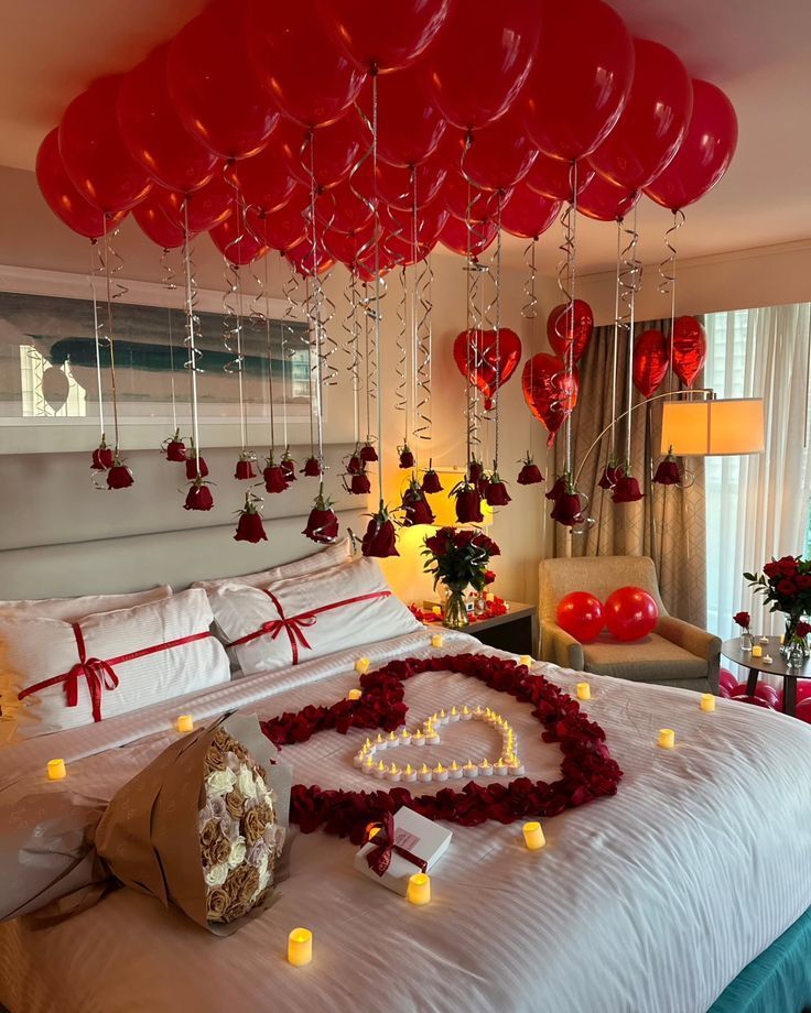 Red balloons and red roses bedroom setup with candles 