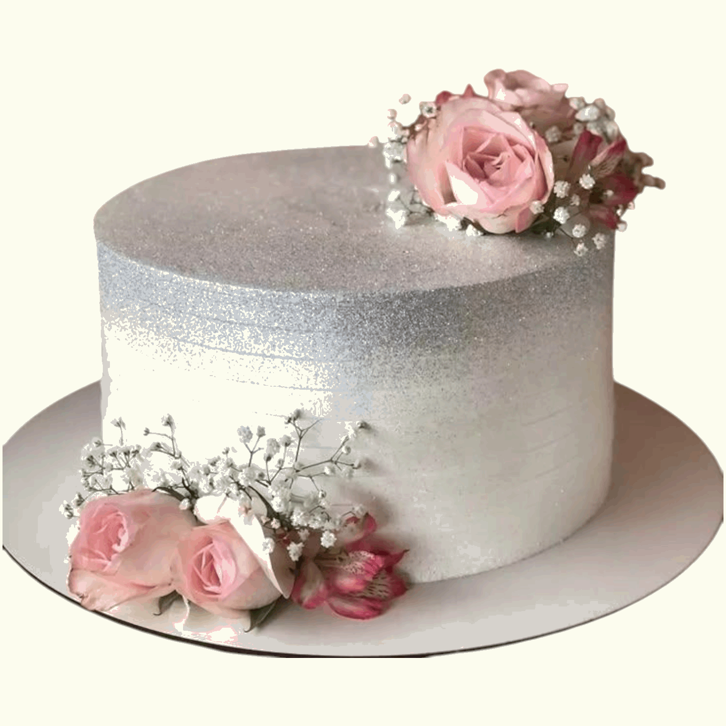 White cake with silver glittery effect and pink roses in Dubai, UAE