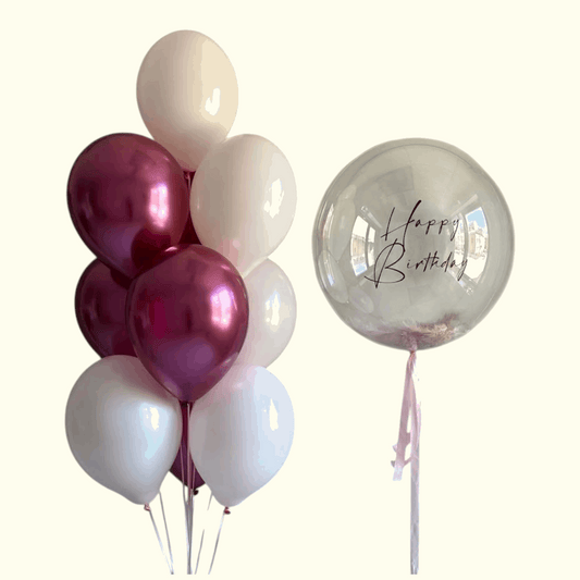 Bouquet of balloons including red, white, and clear 'Happy Birthday' balloon on a white background