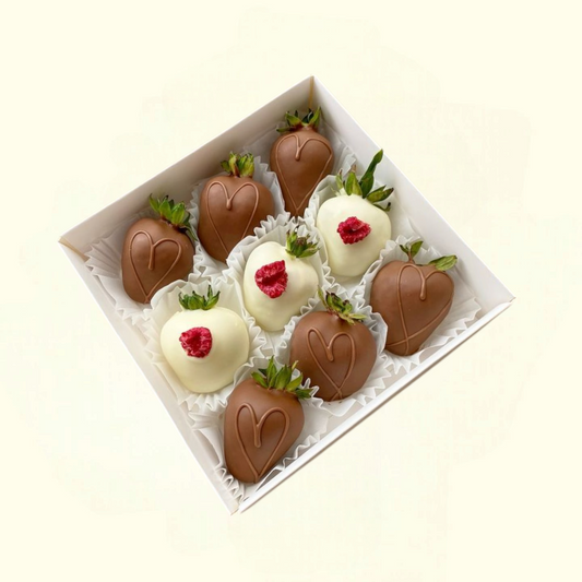 Box of chocolate-covered strawberries with white and milk chocolate on a light beige background