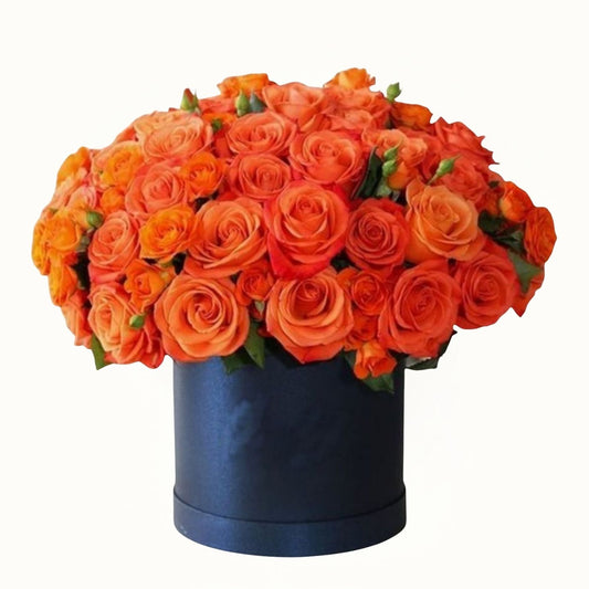 Bouquet of orange roses in a black box 
