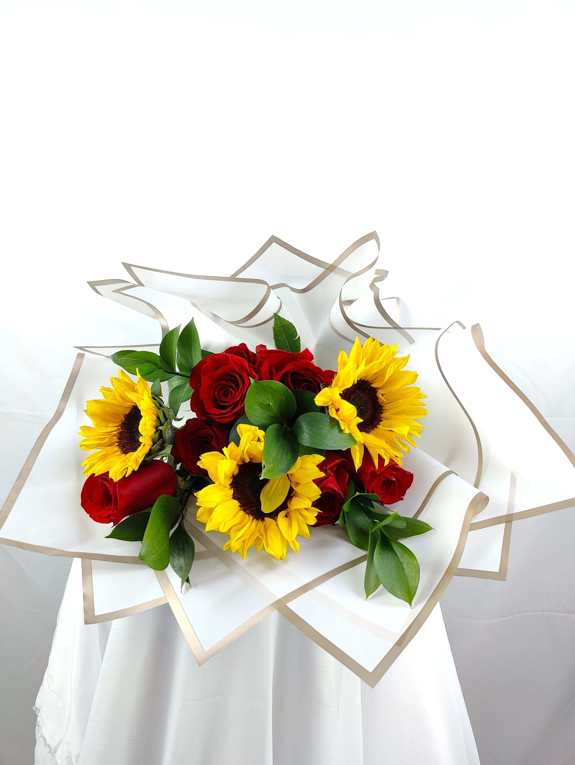 Sunflower and red roses flowers bouquet in Dubai, UAE 