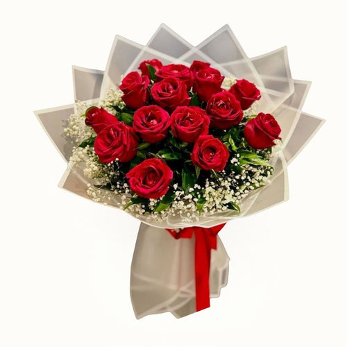 Bouquet of red roses with a red ribbon on a white background