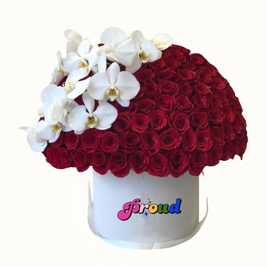 White box with red roses and white orchids, featuring the word 'Proud' 