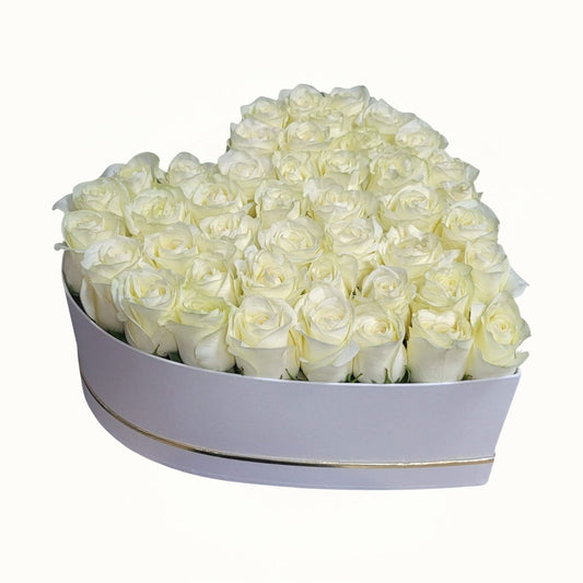 Heart-shaped box filled with white roses 