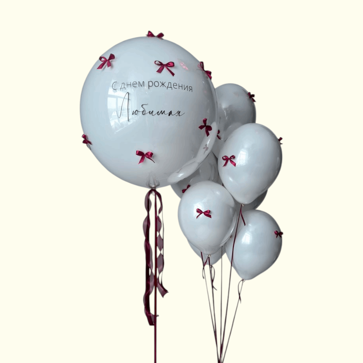 White balloons with red ribbons and text on a white background